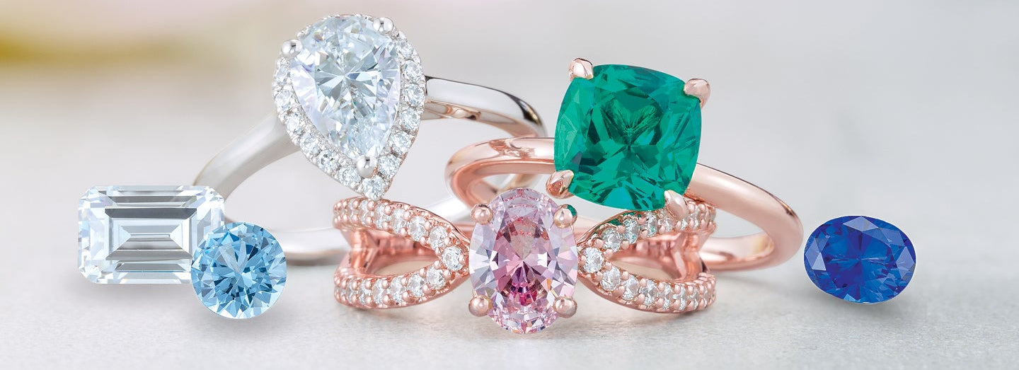 Set of colorful gemstone rings on a light background
